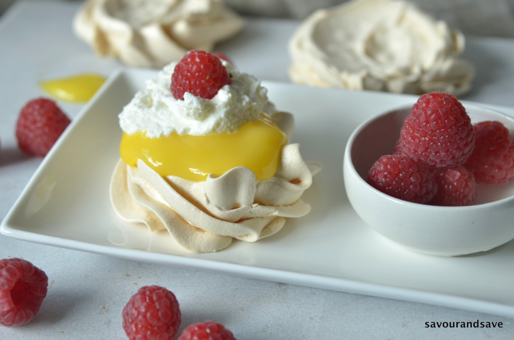 Top lemon curd in meringue finished off with a few berries